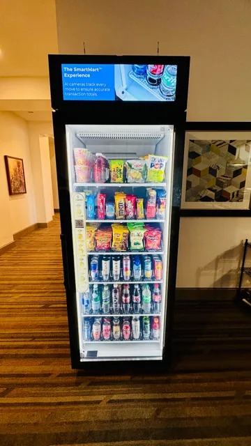 Smart vending cooler with a digital display screen in a hotel corridor